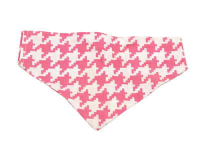 Pink and white houndstooth patterned bandana on a white background