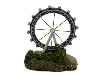 Ferris wheel model on a base with greenery against a white background