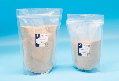 Small animal bathing sand in 1kg and 500g resealable pouches on blue background
