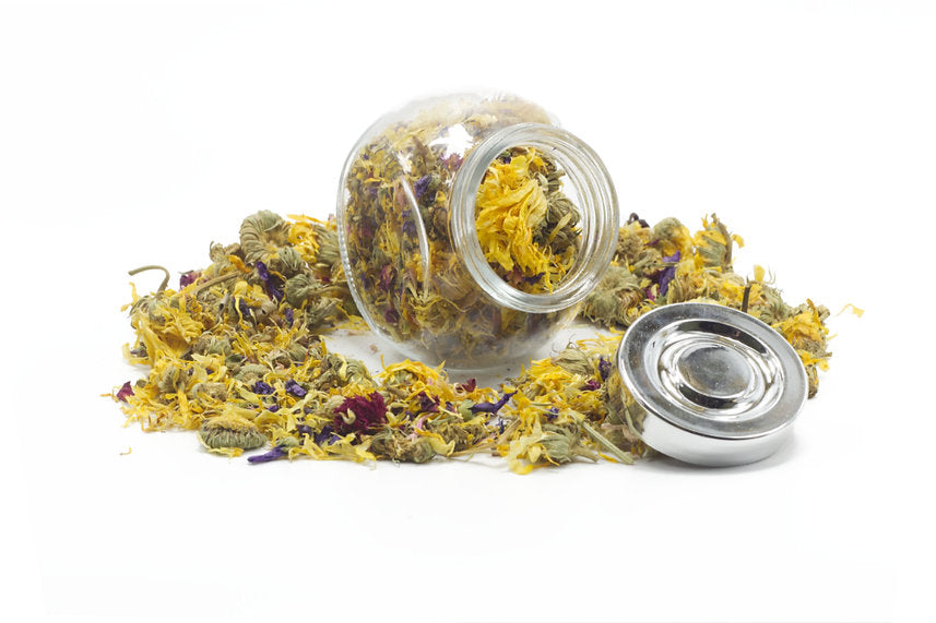 A jar filled with dried mixed flowers