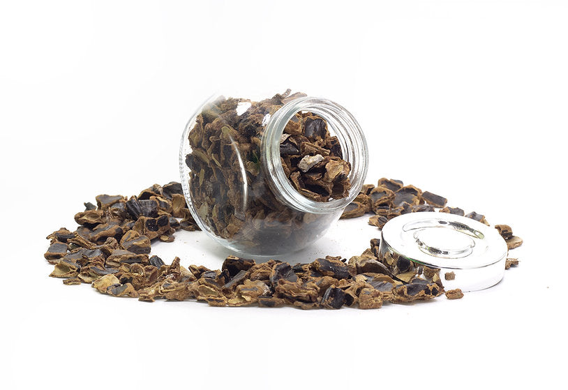 A jar filled with Carob Flakes