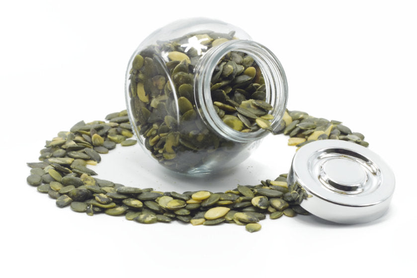 A jar filled of shelled pumpkin seeds