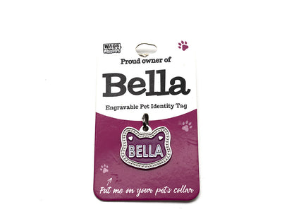 Engravable pet identity tag for Bella on a purple card with Wag Whistle branding.