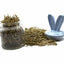 Glass jar filled with dried green oat forage with a small blue bunny dish, on a white background"