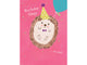 Birthday card with a hedgehog wearing a party hat and balloons on a pink background