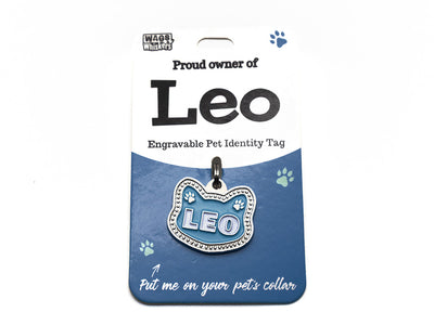 Engravable pet identity tag for Leo on a blue card with Wag Whiskers branding.
