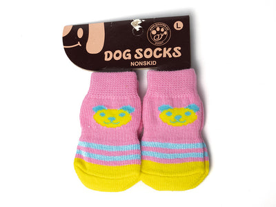 Pink dog socks with cartoon face design on a white background