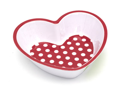Heart-shaped bowl with red polka dot interior on a white background