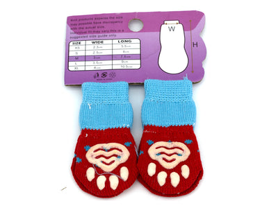 Pair of red pet socks with paw design on a purple card with size chart