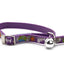 A purple pet collar featuring a colorful fish and bone pattern, a silver metal buckle, and a small silver bell, shown on a white background.