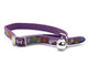 A purple pet collar featuring a colorful fish and bone pattern, a silver metal buckle, and a small silver bell, shown on a white background.