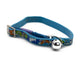 A blue pet collar with a colorful fish and sea creature pattern, featuring a silver metal buckle and a silver bell.