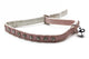 A pink faux-leather cat collar with silver rhinestone studs and a small silver bell, shown on a white background.