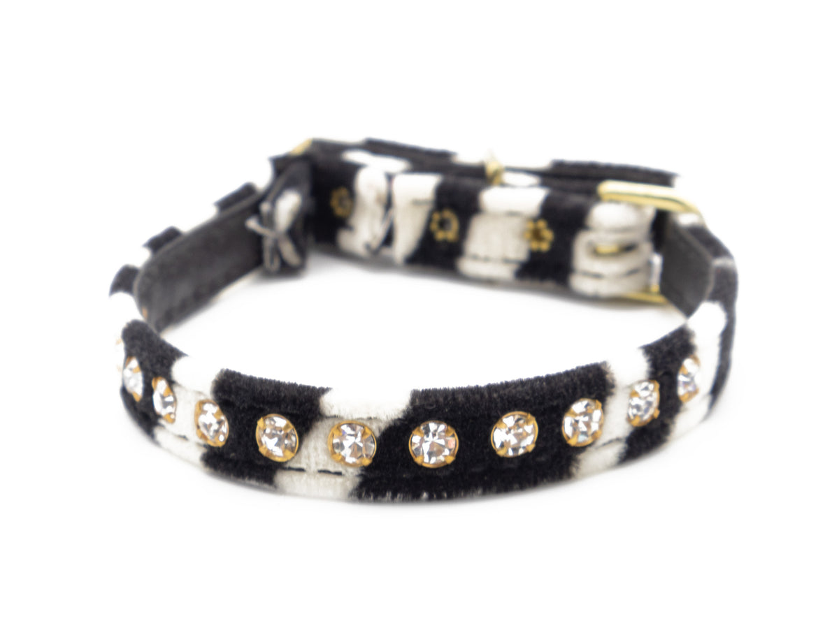 A black and white zebra-print faux fur collar embellished with gold-tone bezel-set clear rhinestones, shown on a plain white background.