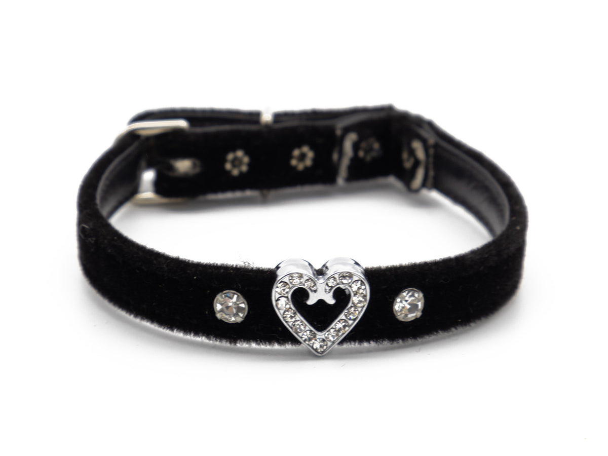 A black velvet collar with a silver-tone heart-shaped clasp adorned with clear rhinestones, flanked by two matching rhinestone studs on a white background.