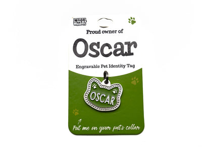Engravable pet identity tag for Oscar on a green card with Wag & Whistle branding.