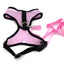 Pink dog harness and leash set on a white background
