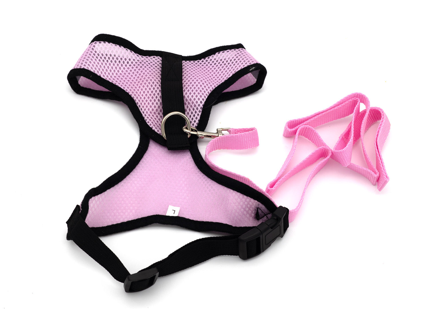 Pink dog harness and leash set on a white background