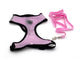 Pink dog harness and leash set on a white background