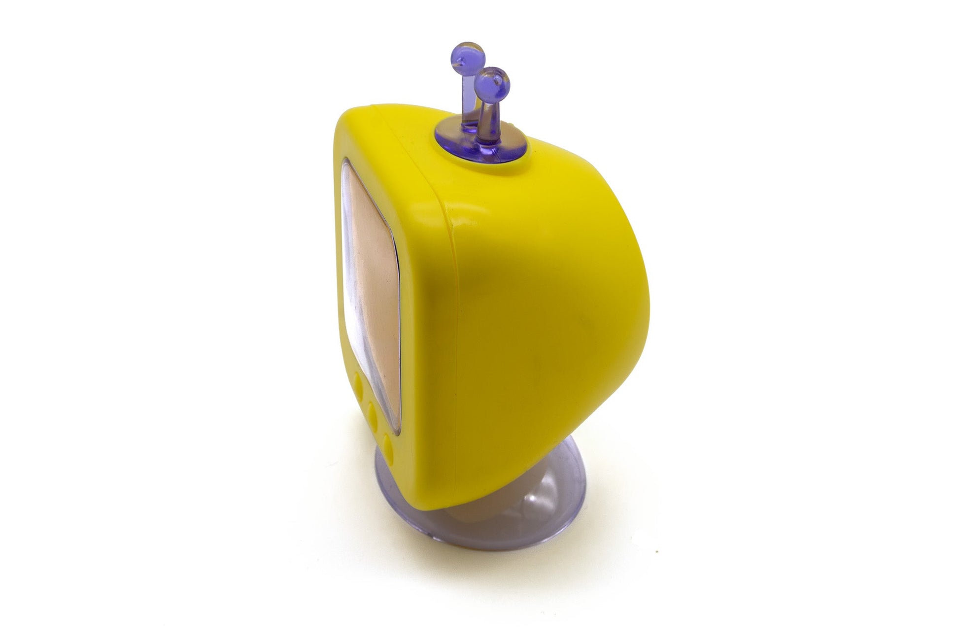A retro-style yellow toy television with a purple antenna and a translucent gray base, photographed on a plain white background.
